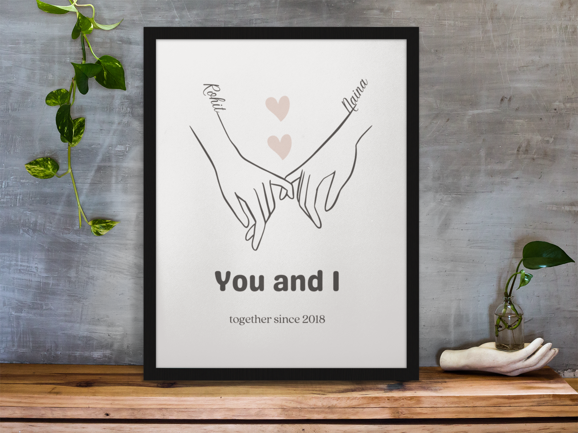 This unique and sentimental frame features an image of two people holding hands and linking pinkies