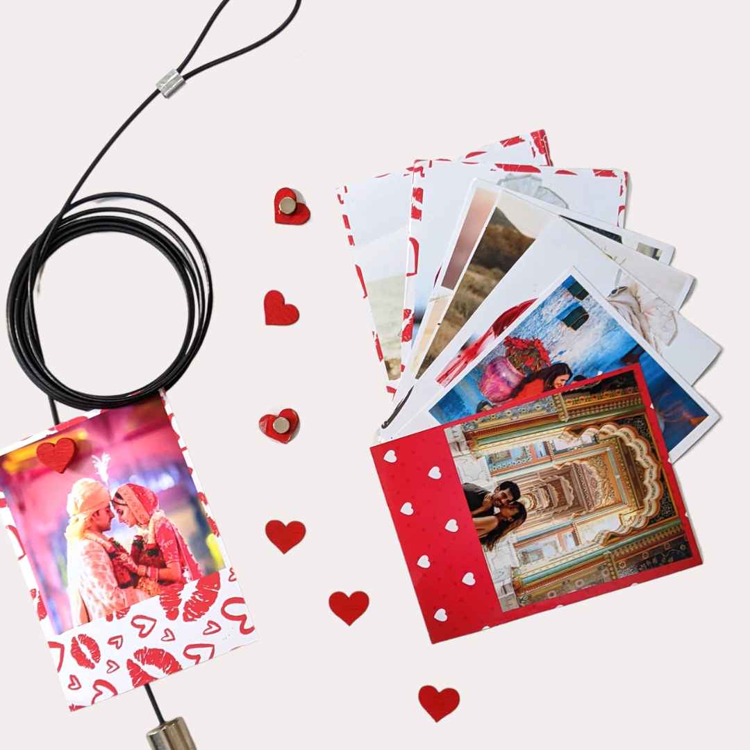 Valentine polaroids hanging on wall with Magnetic photo rope having heart magnets